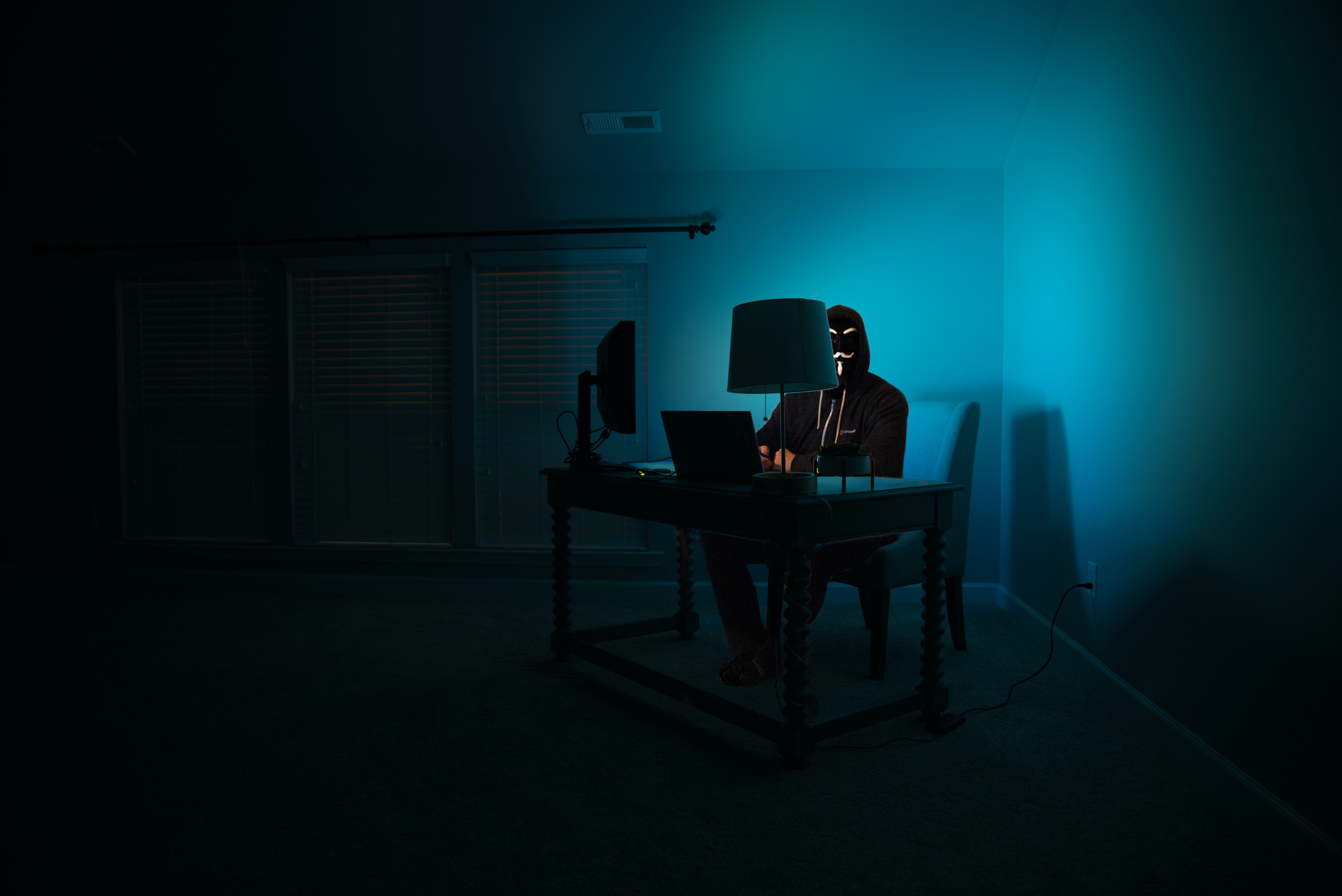 Zdjęcie osoby na komputerze w ciemności
